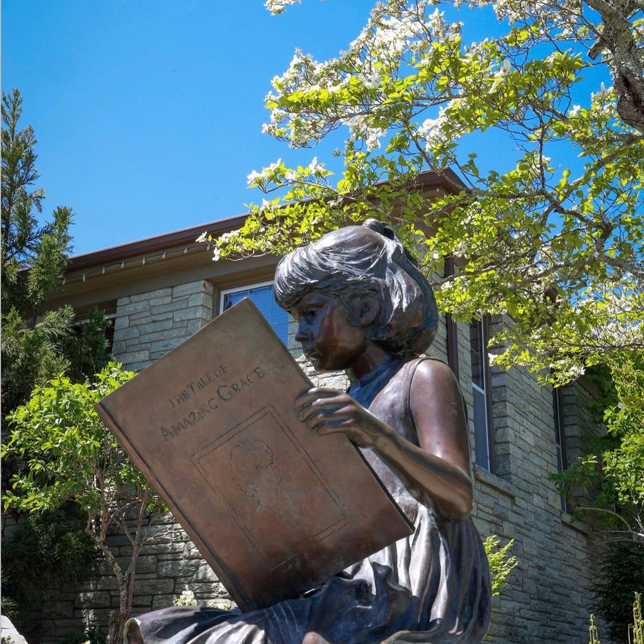 The 'Jessie' bronze statue by artist Cantey T. Kelleher, located in front of the Blowing Rock Community Library on Main Street, a favorite stop on our historic walking tours.